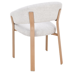 Three-quarter view of light gray upholstered dining chair with oak legs and arm supports