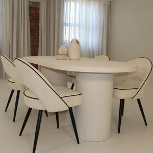Modern dining set with a white table and chairs in a minimalistic room.