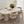 Modern dining room with a white oval table and chairs, featuring a vase of sunflowers.