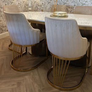 Dining room with a table and chairs against a decorative wall.