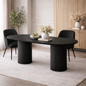 Modern black dining table with chairs in a room with wooden flooring and light-colored walls.