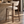 Walnut barstool with light beige fabric seat and curved backrest, open X frame