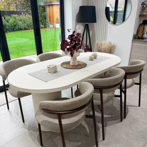 Round white table with decorative items in a modern indoor setting