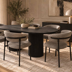Oval dining table set with four textured gray dining chairs and black tapered legs