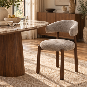 Walnut dining chair with curved back and padded light gray seat