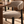 Gray upholstered dining chair seat and curved armrest with black legs close-up