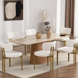 Dining room with a wooden table and white chairs in a modern interior setting.