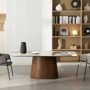 Modern dining area with a wooden table and gray chairs in a well-lit room.