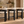 Multiple black wood barstools with cream upholstered seats