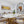 Modern dining room with round table, chairs, and decorative elements.