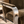 Corra khaki armchair detail with textured upholstery and polished metal armrest