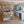 Modern kitchen with white cabinets, a dining area, and decorative elements.