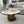 Modern living room with a marble coffee table, decorative items, and a gray sofa.