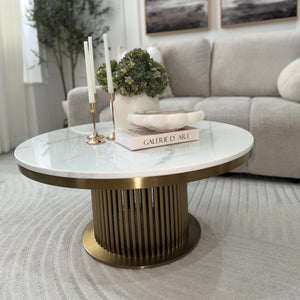 Modern living room with a marble coffee table, decorative items, and a gray sofa.