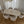 Dining room with a white oval table and matching chairs on a wooden floor.