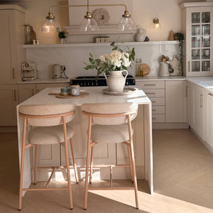 Modern kitchen interior with a staircase leading to an upper level.