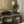 Dining area with chairs, a plant, and decorative wall lights.