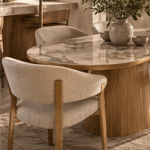 Round marble-effect dining table with beige upholstered chair and oak frame