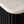 Close-up of a modern black ribbed cabinet or sideboard with a white marble-look top surface.